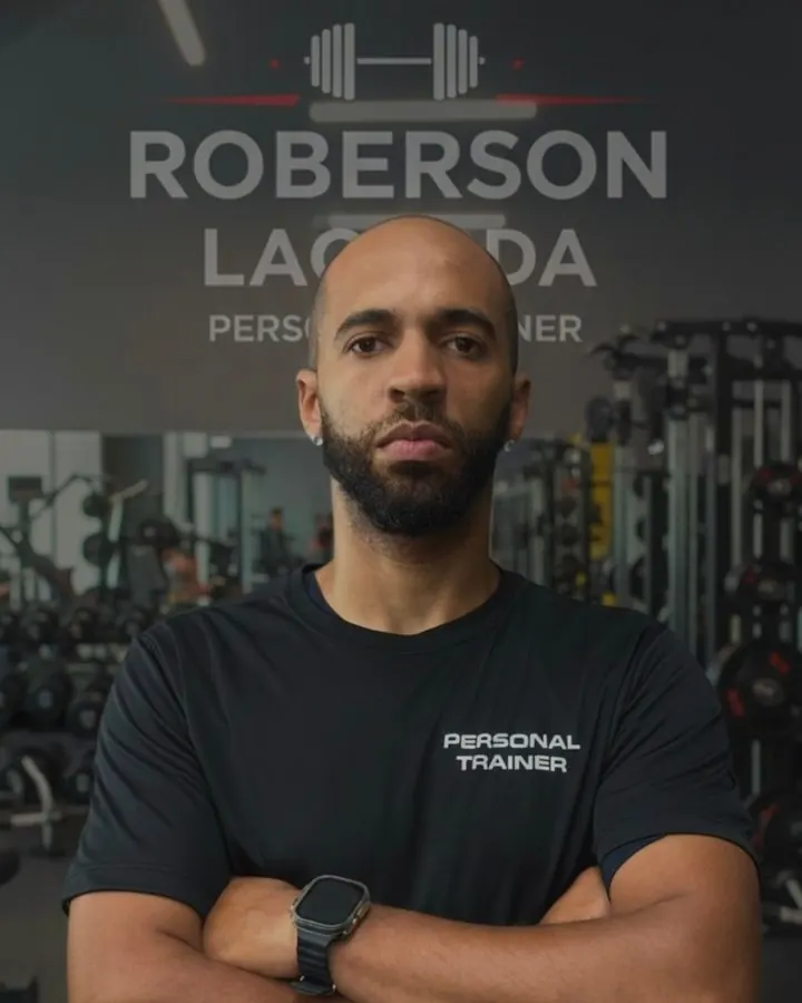Retrato do personal trainer em frente ao painel da marca