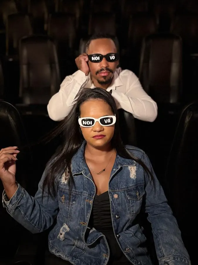 Casal com óculos escritos noiva e noivo nas poltronas do cinema